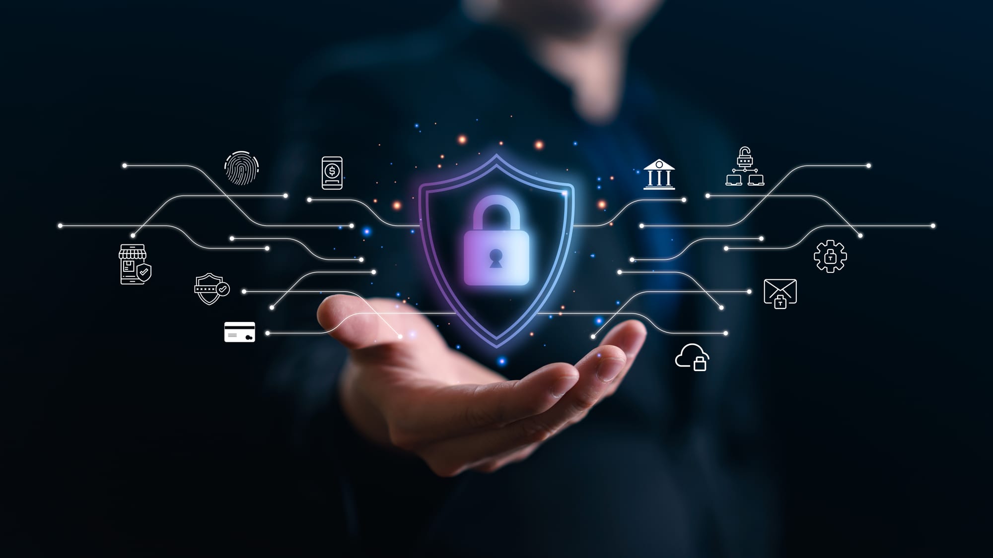 An open hand beneath a glowing padlock inside a shield, with lines running out to icons for a bank, a fingerprint, a card payment, email and cloud storage.